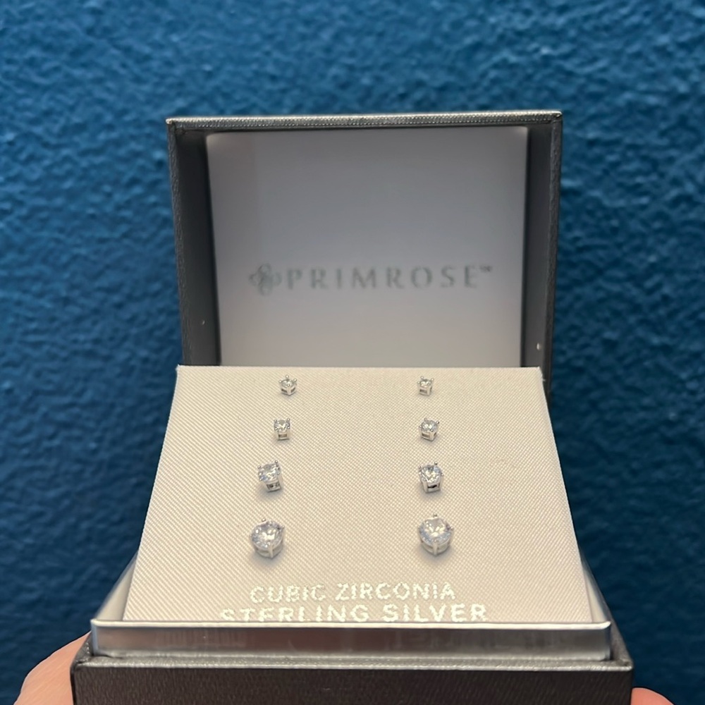 Set of four cubic zirconia studs in sterling silver.
